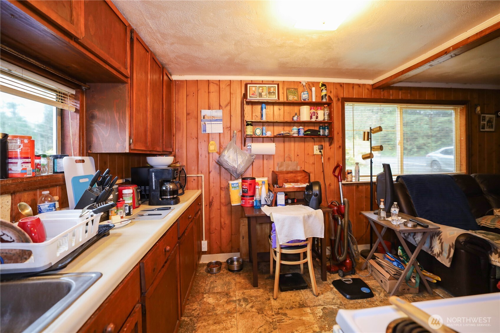 6703 Karjala Road Aberdeen, WA 98520 - Photo 5 of 15 a view of a kitchen with a dining table chairs and a kitchen