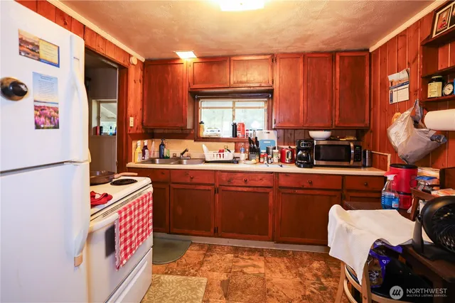 a kitchen with a refrigerator and a sink