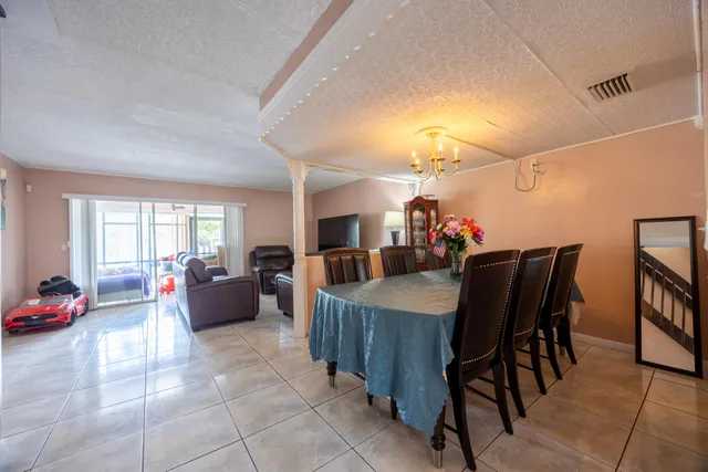 a dining room with furniture and wooden floor