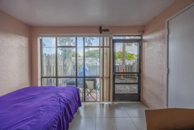 a bed sitting in a bedroom next to a window