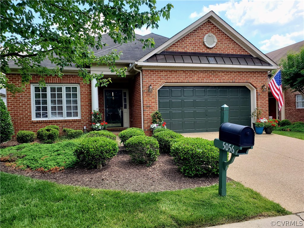 5056 Park Commons Loop Glen Allen, VA 23059 - Photo 2 of 29 a front view of a house with garden