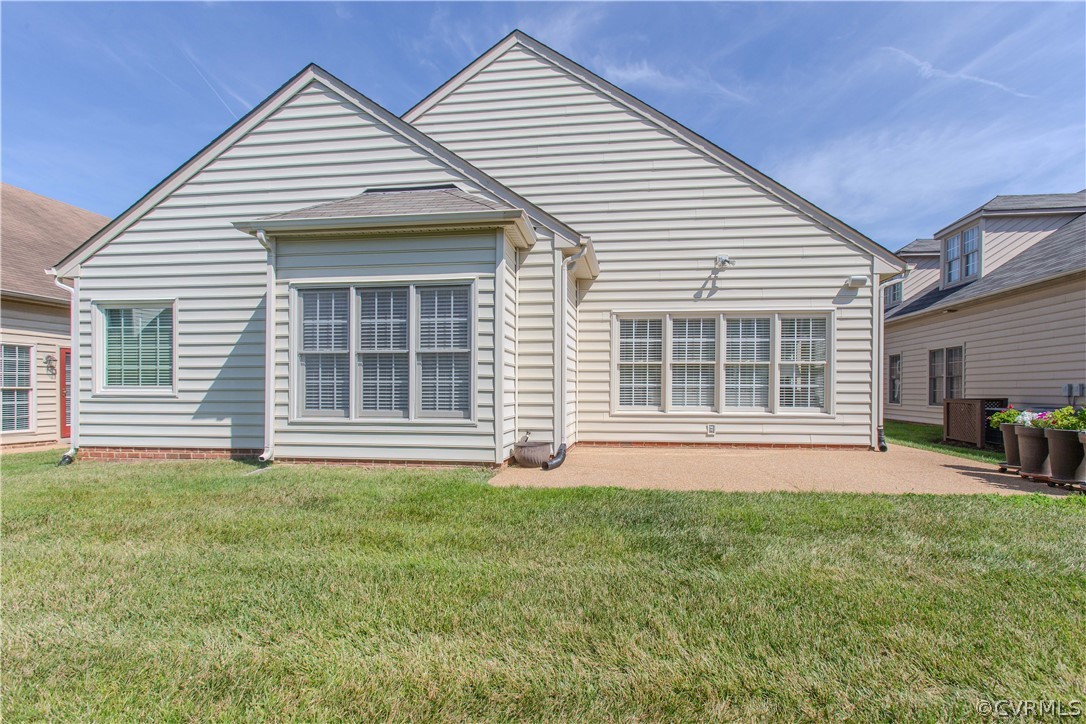 5056 Park Commons Loop Glen Allen, VA 23059 - Photo 26 of 29 a front view of a house with a garden and porch