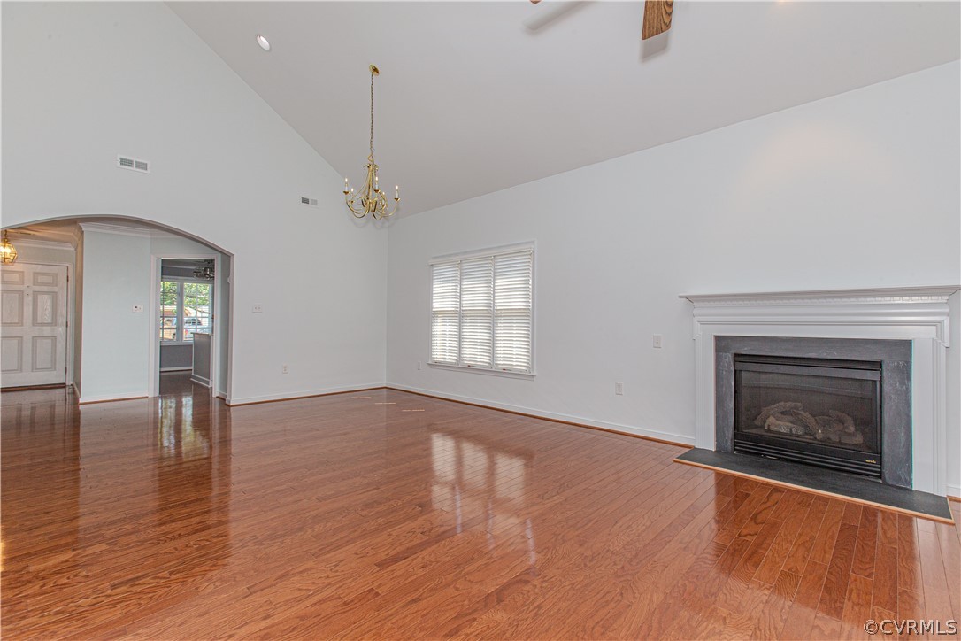 5056 Park Commons Loop Glen Allen, VA 23059 - Photo 7 of 29 an empty room with wooden floor fireplace and windows
