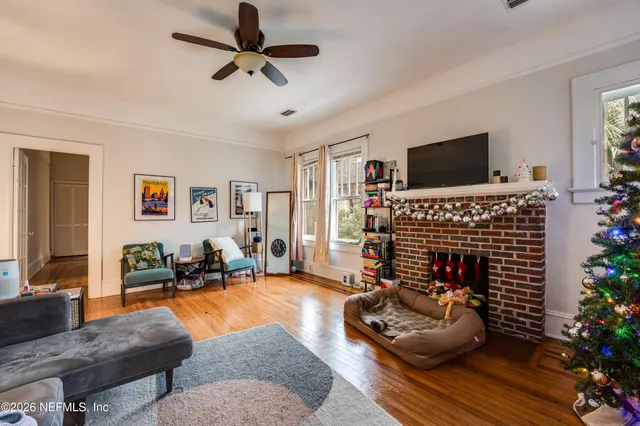 a living room with furniture and wooden floor