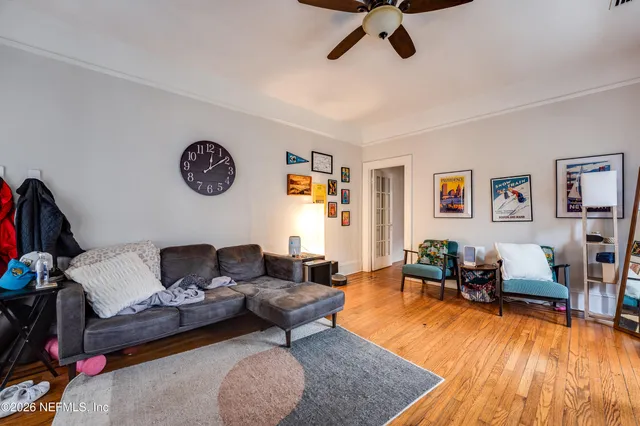a living room with furniture and flowers
