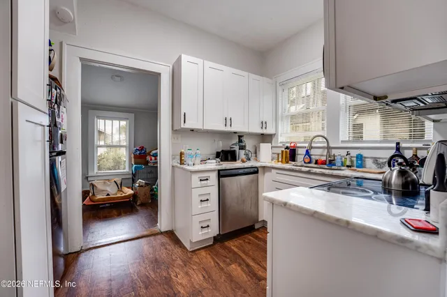 a kitchen with stainless steel appliances granite countertop a sink stove and cabinets