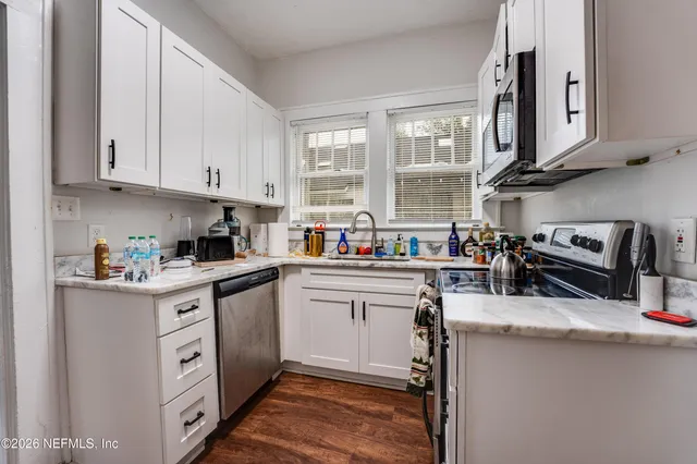 a kitchen with stainless steel appliances granite countertop a lot of counter space and a sink