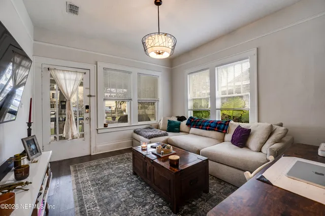 a living room with furniture and a flat screen tv