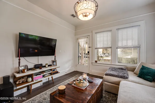a living room with furniture and a flat screen tv