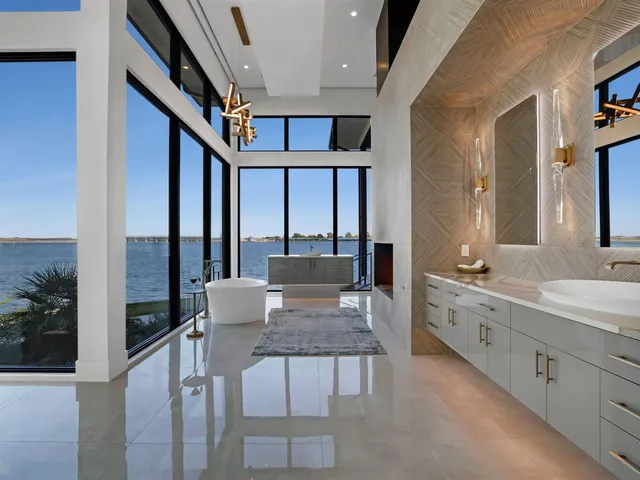 a dining room with furniture and a large window