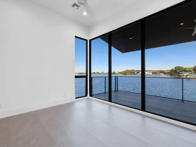 an empty room with sliding door and mountain view