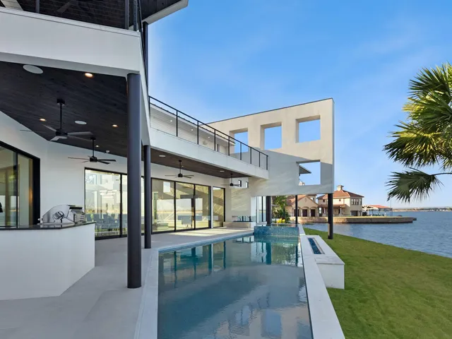 a view of a house with swimming pool and sitting area