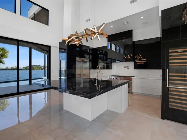 a kitchen with stainless steel appliances granite countertop a sink and a refrigerator