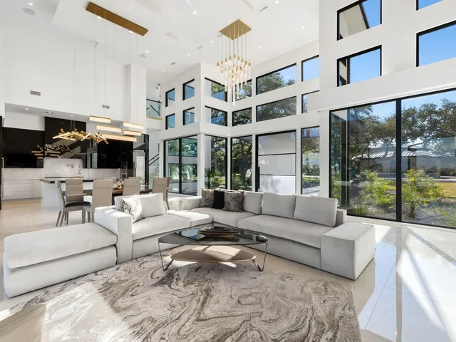 a living room with furniture large window and flat screen tv