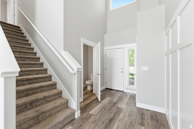1614 Aspen Loop Provo, UT 84606 - Photo 5 of 47 Two-story entryway with wood-finish flooring, board and batten wall detailing, and a carpeted staircase