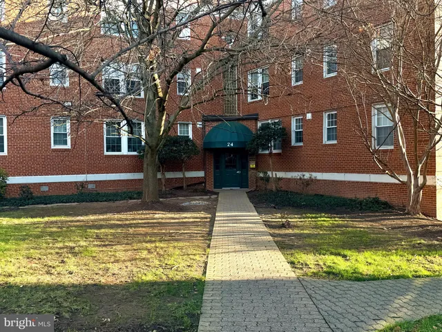 a view of a house with swimming pool next to a large tree