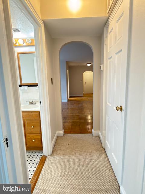 24 South Old Glebe Road, Unit 202 Arlington, VA 22204 - Photo 11 of 22 a view of a hallway view with wooden floor and staircase