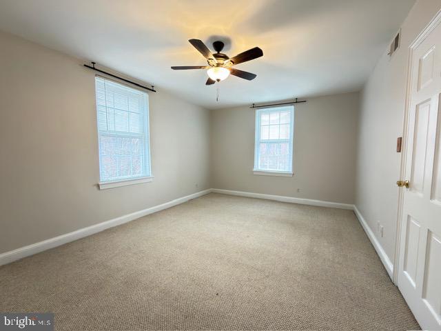 24 South Old Glebe Road, Unit 202 Arlington, VA 22204 - Photo 17 of 22 an empty room with window and ceiling fan