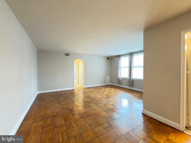 24 South Old Glebe Road, Unit 202 Arlington, VA 22204 - Photo 3 of 22 an empty room with wooden floor and windows