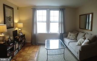24 South Old Glebe Road, Unit 202 Arlington, VA 22204 - Photo 7 of 22 a living room with furniture and a window