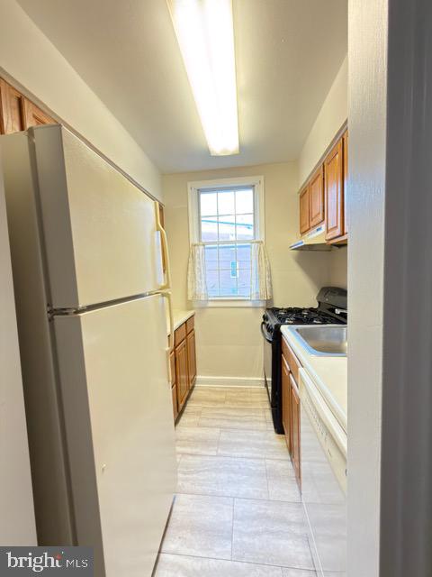 24 South Old Glebe Road, Unit 202 Arlington, VA 22204 - Photo 8 of 22 a kitchen with stainless steel appliances granite countertop a refrigerator a stove a sink and a microwave