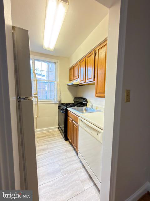 24 South Old Glebe Road, Unit 202 Arlington, VA 22204 - Photo 9 of 22 a kitchen with stainless steel appliances granite countertop a refrigerator and a sink