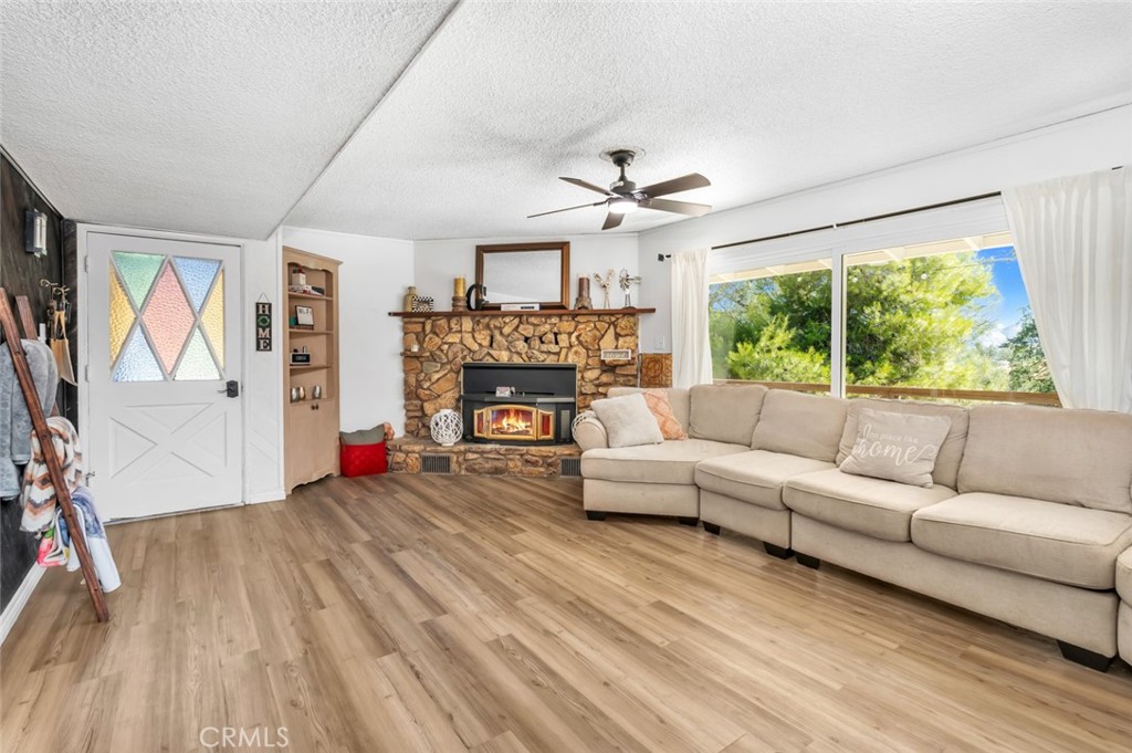245 Mountain Shadow Road Wofford Heights, CA 93285 - Photo 5 of 72 a living room with furniture and a fireplace