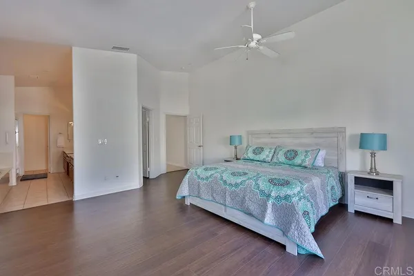 a spacious bedroom with a bed and a window