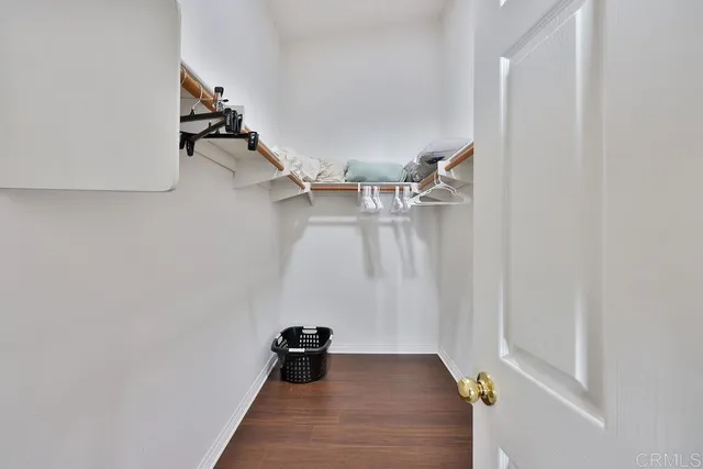 a bedroom with a bed window and dresser