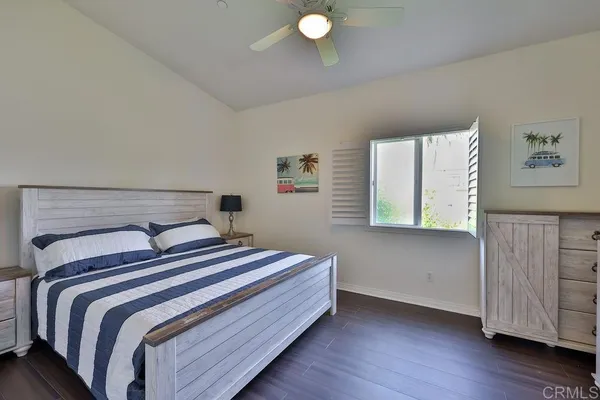 a bedroom with two beds and a large window