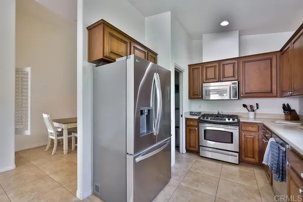 a kitchen with stainless steel appliances granite countertop a sink and a stove