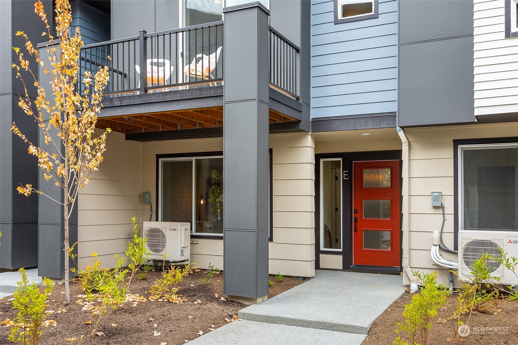 616 237th Place Southeast, Unit E Bothell, WA 98021 - Photo 27 of 27 a front view of a house with a chairs and table