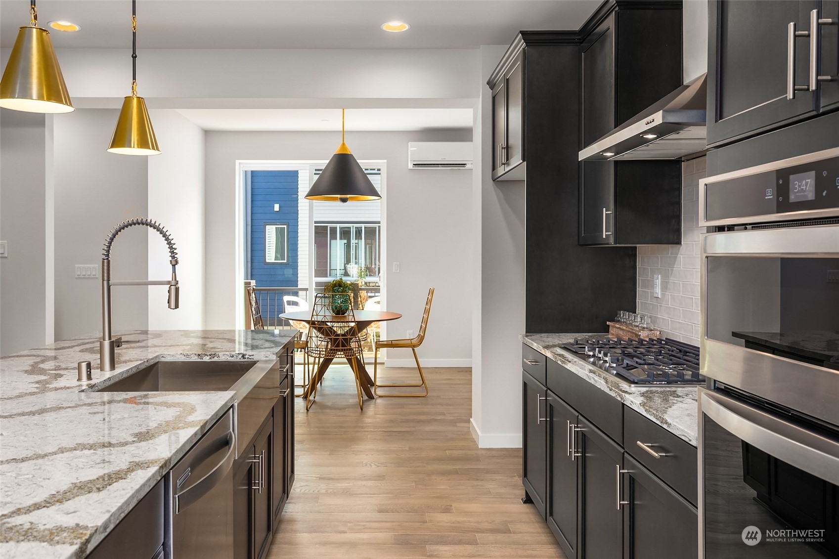 616 237th Place Southeast, Unit E Bothell, WA 98021 - Photo 5 of 27 a kitchen with stainless steel appliances kitchen island granite countertop a stove a sink and a refrigerator