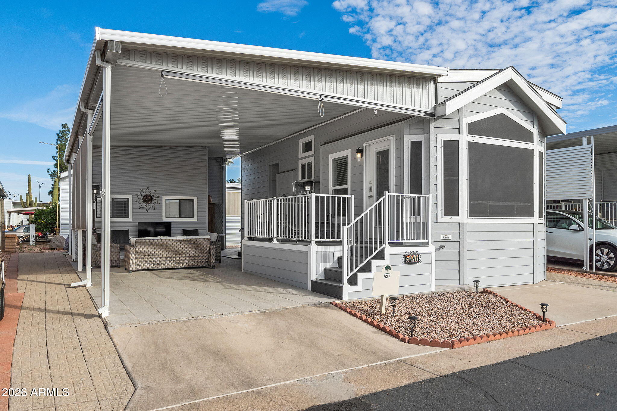 111 South Greenfield Road, Unit 527 Mesa, AZ 85206 - Photo 1 of 15 a view of a white house with large windows