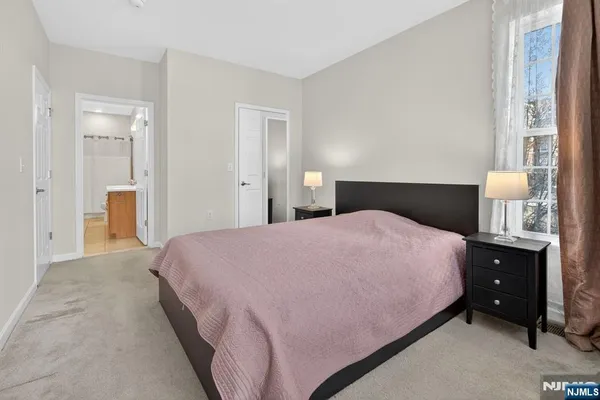 a bedroom with a bed and a lamp