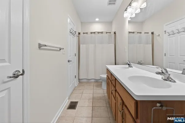 a bathroom with a sink a mirror and a shower
