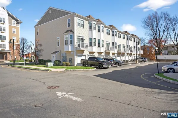 a city street lined with buildings and cars parked