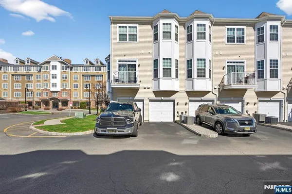 a car parked in front of a white house