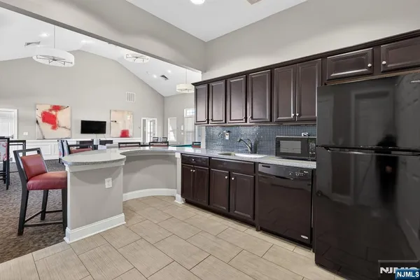a kitchen with cabinets a sink and white appliances
