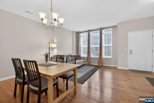 a view of a dining room with furniture wooden floor and chandelier