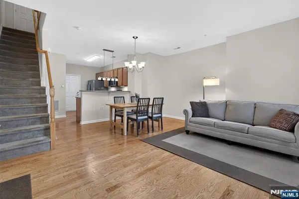 a living room with furniture and a chandelier