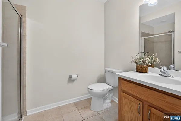 a bathroom with a sink toilet and mirror