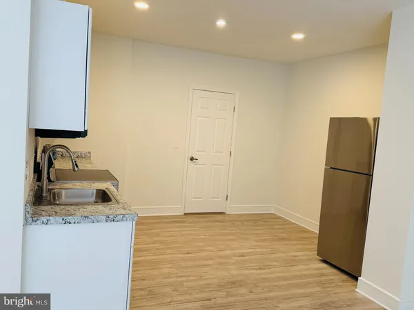 a bathroom with a sink a refrigerator and a stove