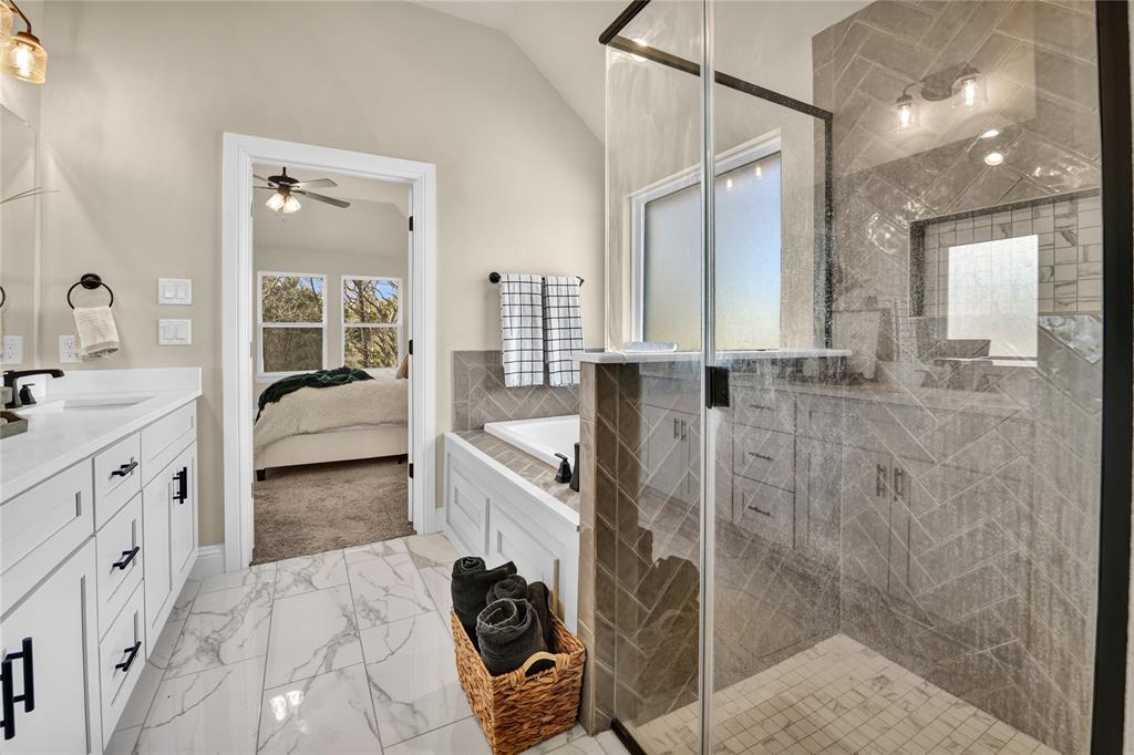 2044 Redemption Drive Weatherford, TX 76088 - Photo 19 of 30 a en suite bathroom with a tub sink and mirror