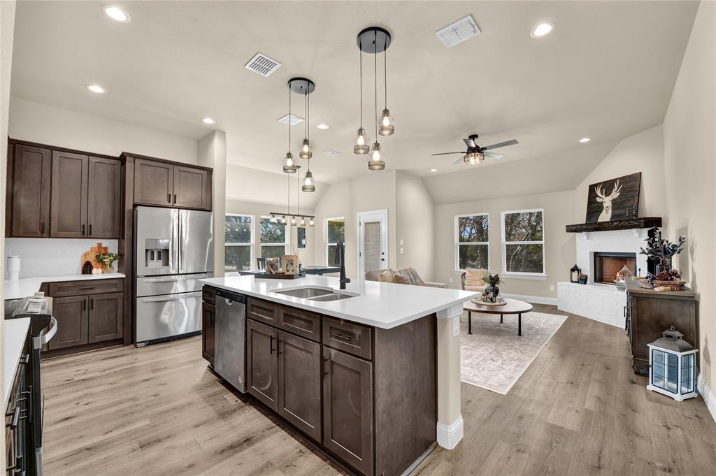 2044 Redemption Drive Weatherford, TX 76088 - Photo 21 of 30 a kitchen with a sink stove and wooden cabinets