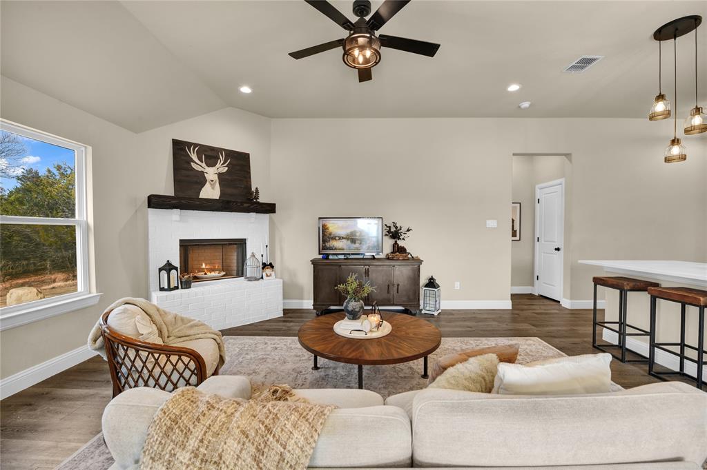 2044 Redemption Drive Weatherford, TX 76088 - Photo 25 of 30 a living room with furniture and a fireplace