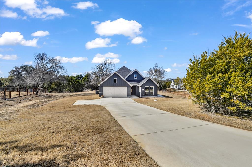 2044 Redemption Drive Weatherford, TX 76088 - Photo 6 of 30 a front view of a house with a yard and garage