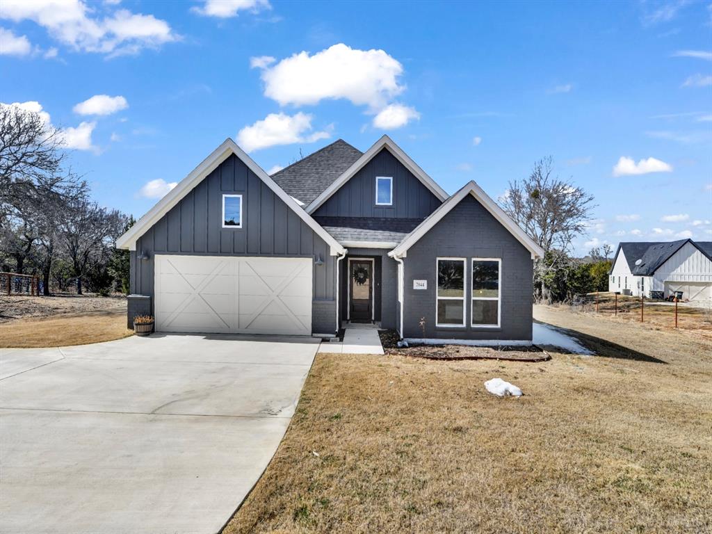 2044 Redemption Drive Weatherford, TX 76088 - Photo 7 of 30 a front view of a house with yard and trees in the background