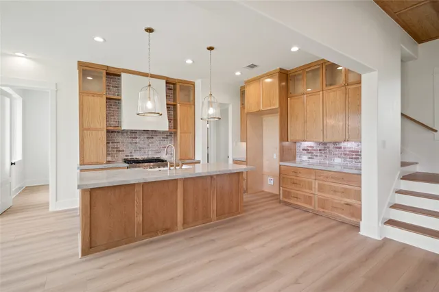 a bathroom with a granite countertop sink mirror and a bathtub