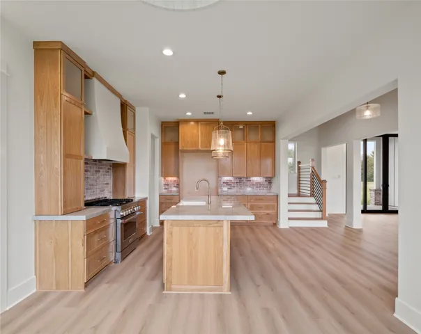 a kitchen with a sink stainless steel appliances and cabinets